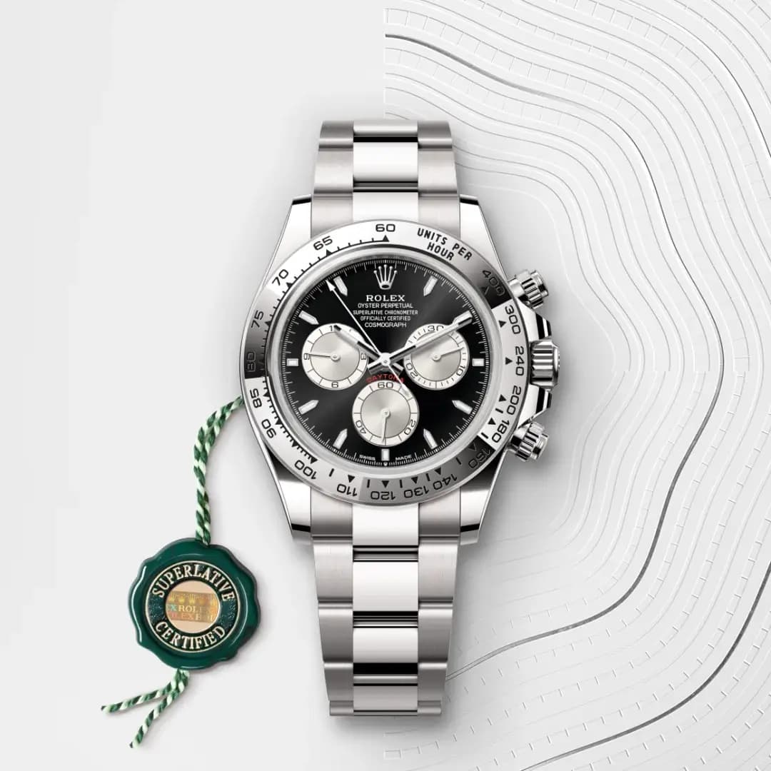 Rolex Cosmograph Daytona with black dial and silver subdials on Oystersteel bracelet.