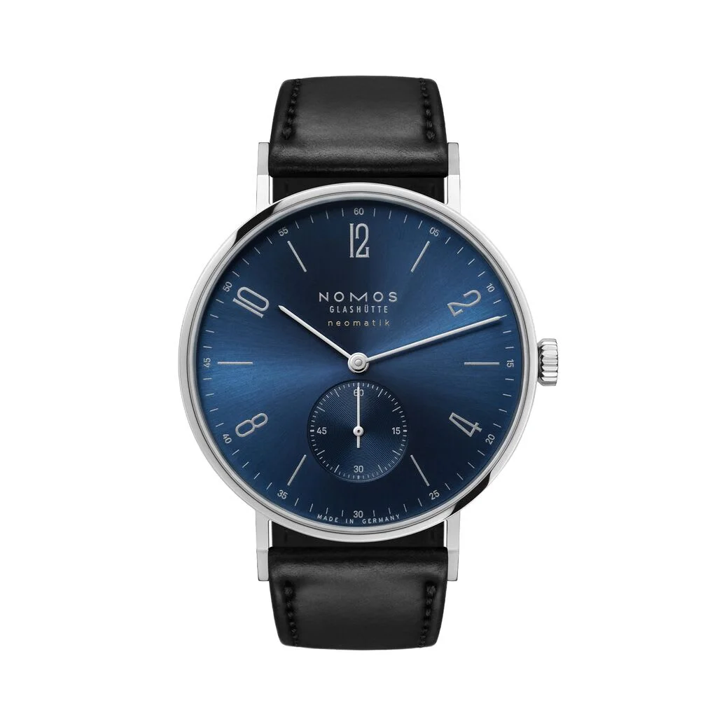 A Nomos Glashütte Tangente Neomatik watch with a deep blue dial and minimalist Bauhaus design on a black leather strap