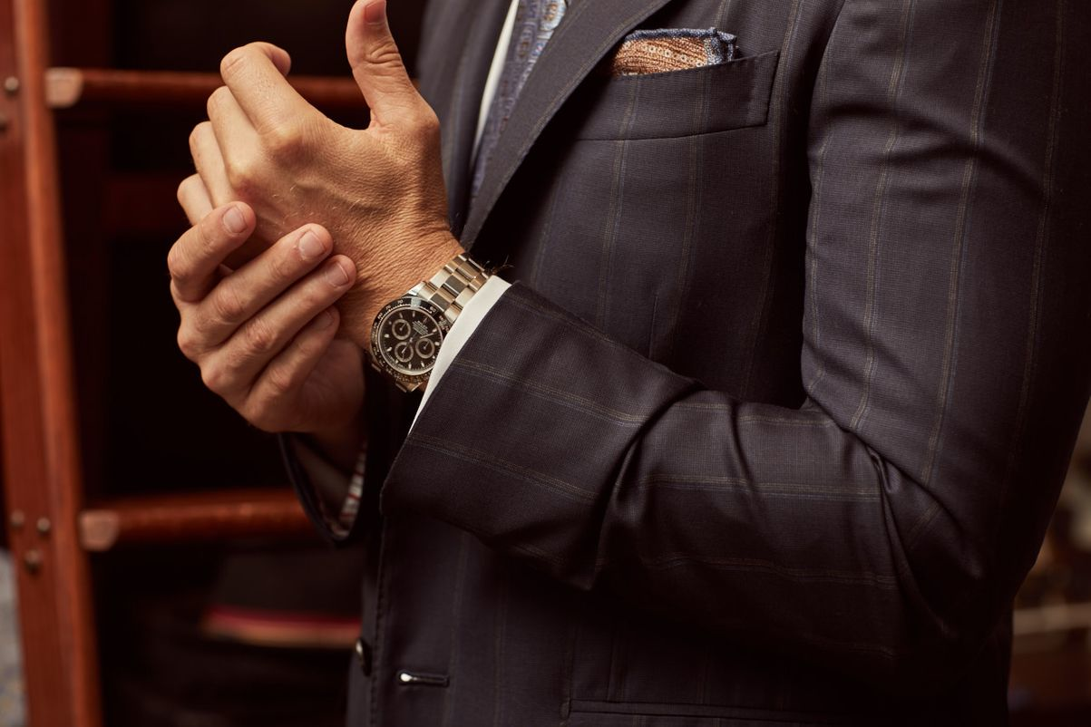 A luxury chronograph watch styled with a formal business suit and pocket square, showcasing sophisticated wristwear for upscale occasions