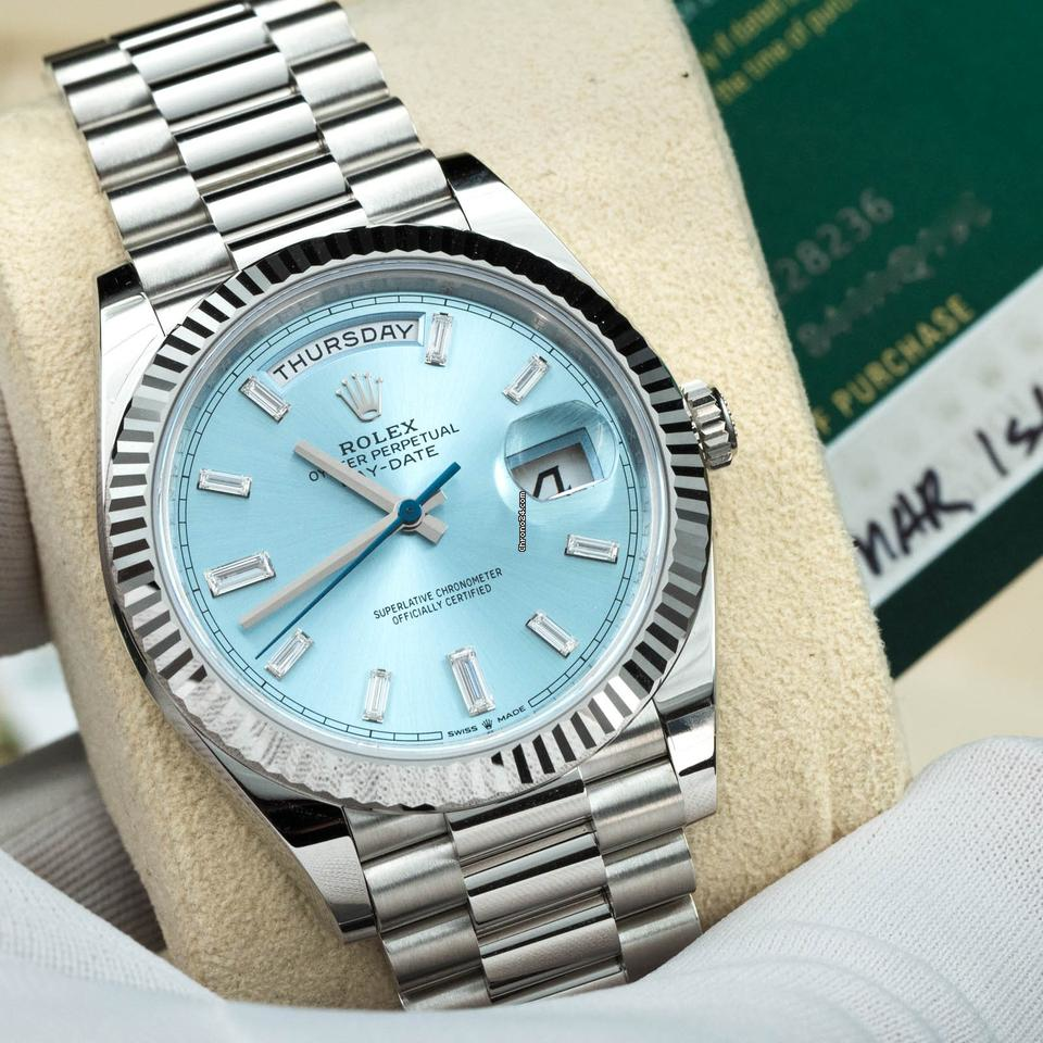 Rolex Day-Date platinum watch with ice blue dial and baguette diamond markers, showcasing premium design and craftsmanship