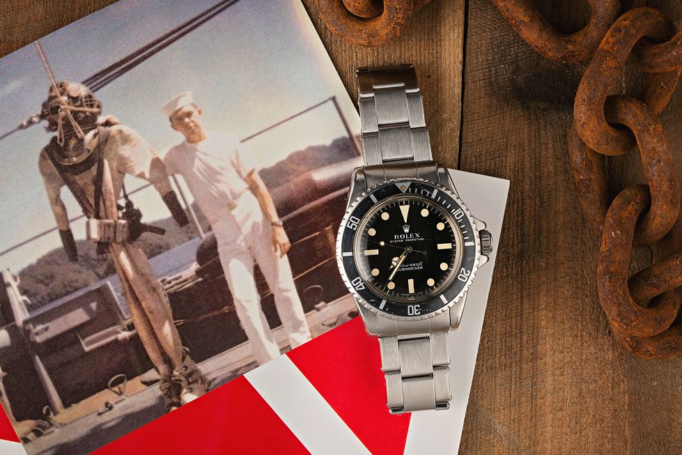 Vintage Rolex Submariner watch with historical diving imagery and maritime elements highlighting its professional diving heritage
