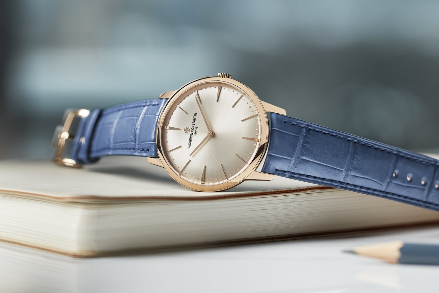 Vacheron Constantin Patrimony wristwatch with gold case and blue leather strap highlighting classic luxury design
