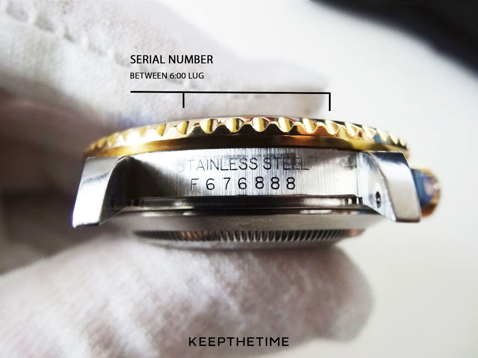 Close-up of a Rolex serial number engraved between the 6 o'clock lug on a stainless steel watch case