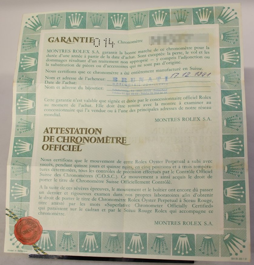 Official Rolex warranty and chronometer certificate with authenticating seal and buyer details