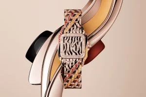 Cartier diamond watch with jungle motif, rose gold case, and multicolored gemstone bracelet.