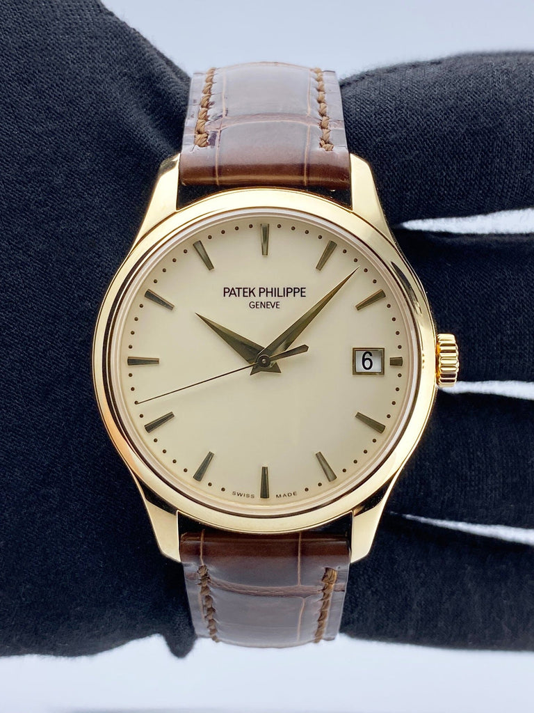 Close-up of Patek Philippe Calatrava 5227J in yellow gold with ivory dial and brown leather strap