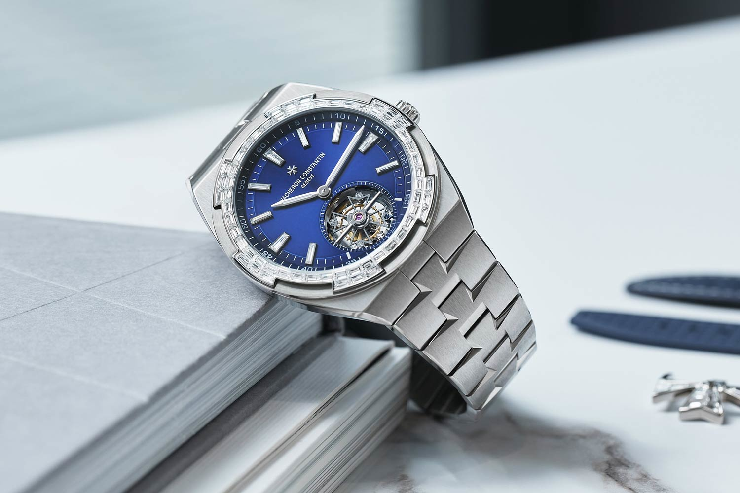 Vacheron Constantin Overseas Tourbillon High Jewellery watch with blue dial, tourbillon mechanism, and gemstone bezel on stainless steel bracelet