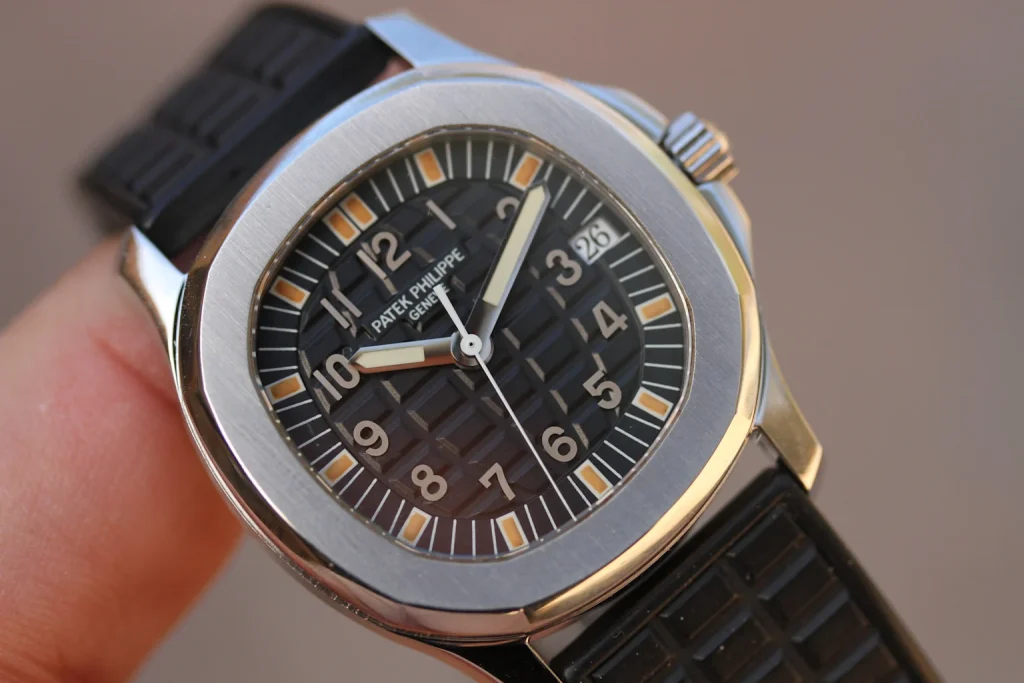 Close-up of Patek Philippe Aquanaut luxury watch with black textured dial and rubber strap