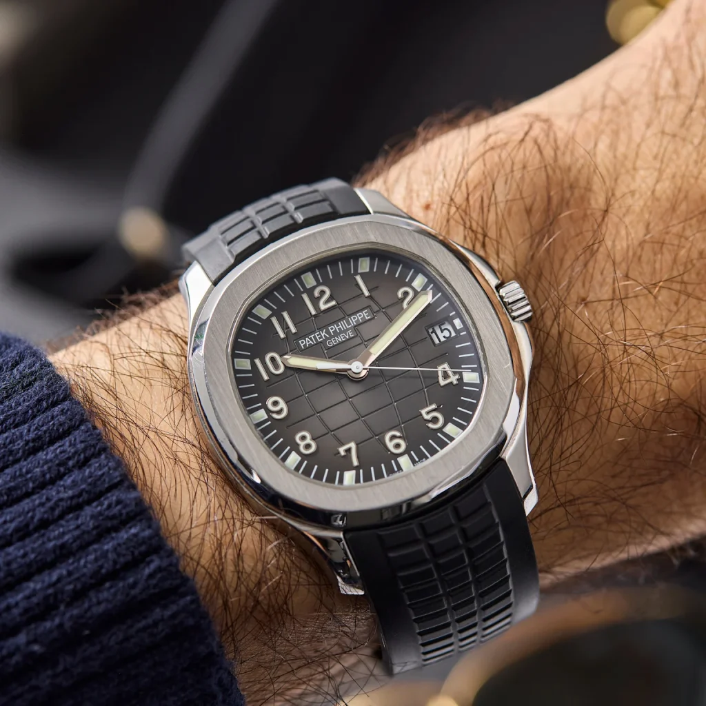 Patek Philippe Aquanaut luxury watch with black dial worn on wrist