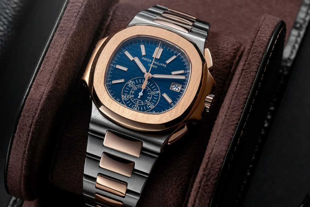 Patek Philippe Nautilus chronograph with blue dial and rose gold bezel on two-tone bracelet.