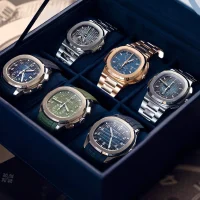 Luxury Patek Philippe Nautilus watches displayed in a velvet-lined collector's box.