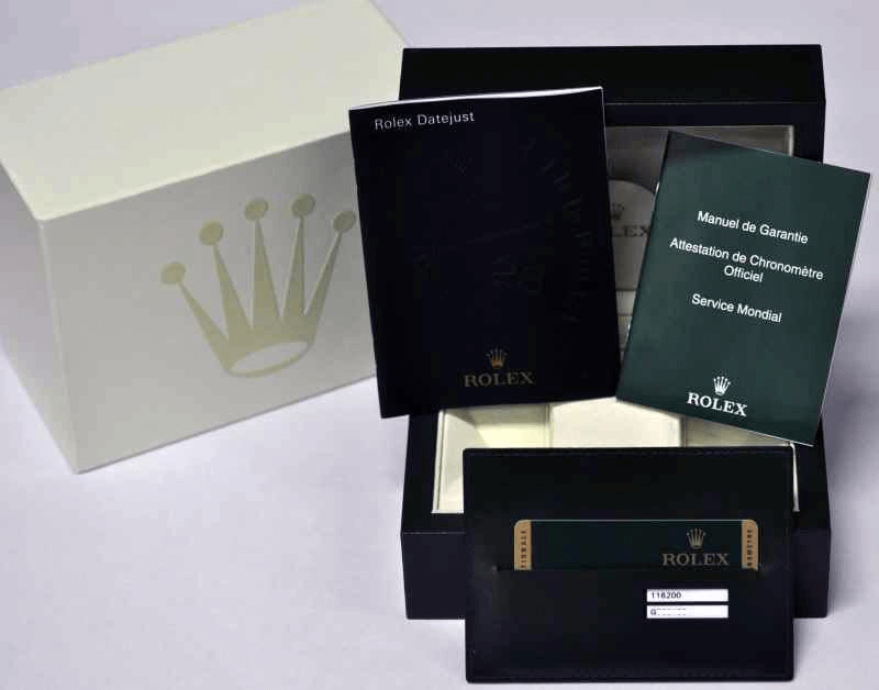 Rolex Datejust watch box with manuals, warranty card, and official papers.