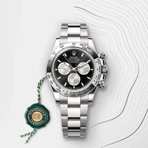 Rolex Cosmograph Daytona with black dial and silver subdials on Oystersteel bracelet.