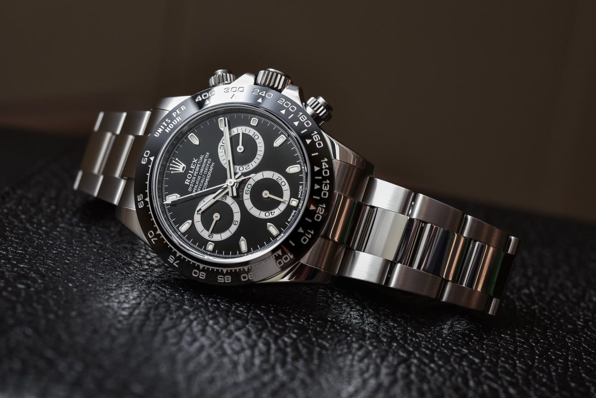 Rolex Cosmograph Daytona in stainless steel with black dial and ceramic bezel on leather background