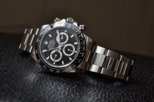 Rolex Cosmograph Daytona in stainless steel with black dial and ceramic bezel on leather background