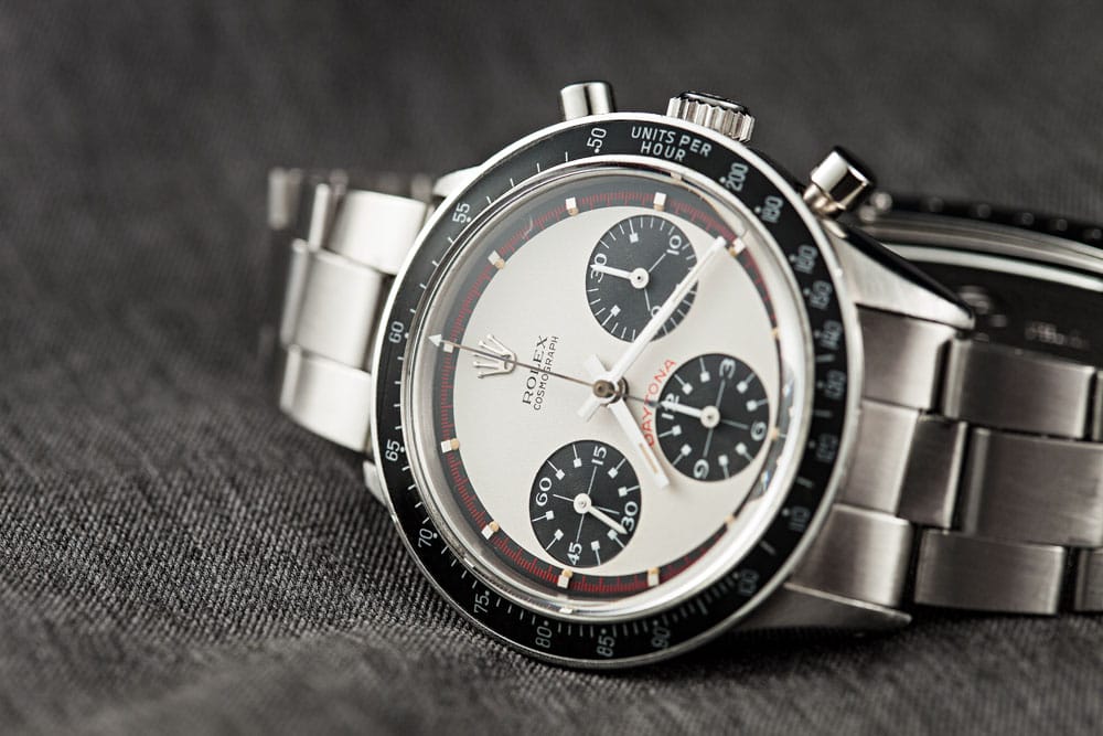 Close-up of vintage Rolex Daytona Paul Newman dial with black subdials and stainless steel bracelet.