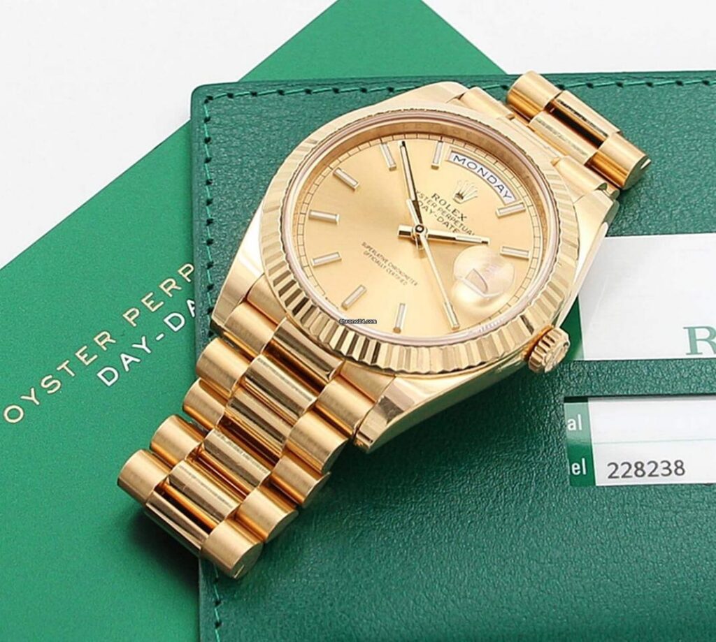 Luxury Rolex Day-Date President watch in yellow gold with champagne dial and fluted bezel.
