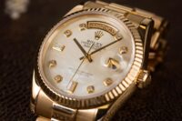 Rolex Day-Date in yellow gold with mother-of-pearl dial and diamond hour markers.