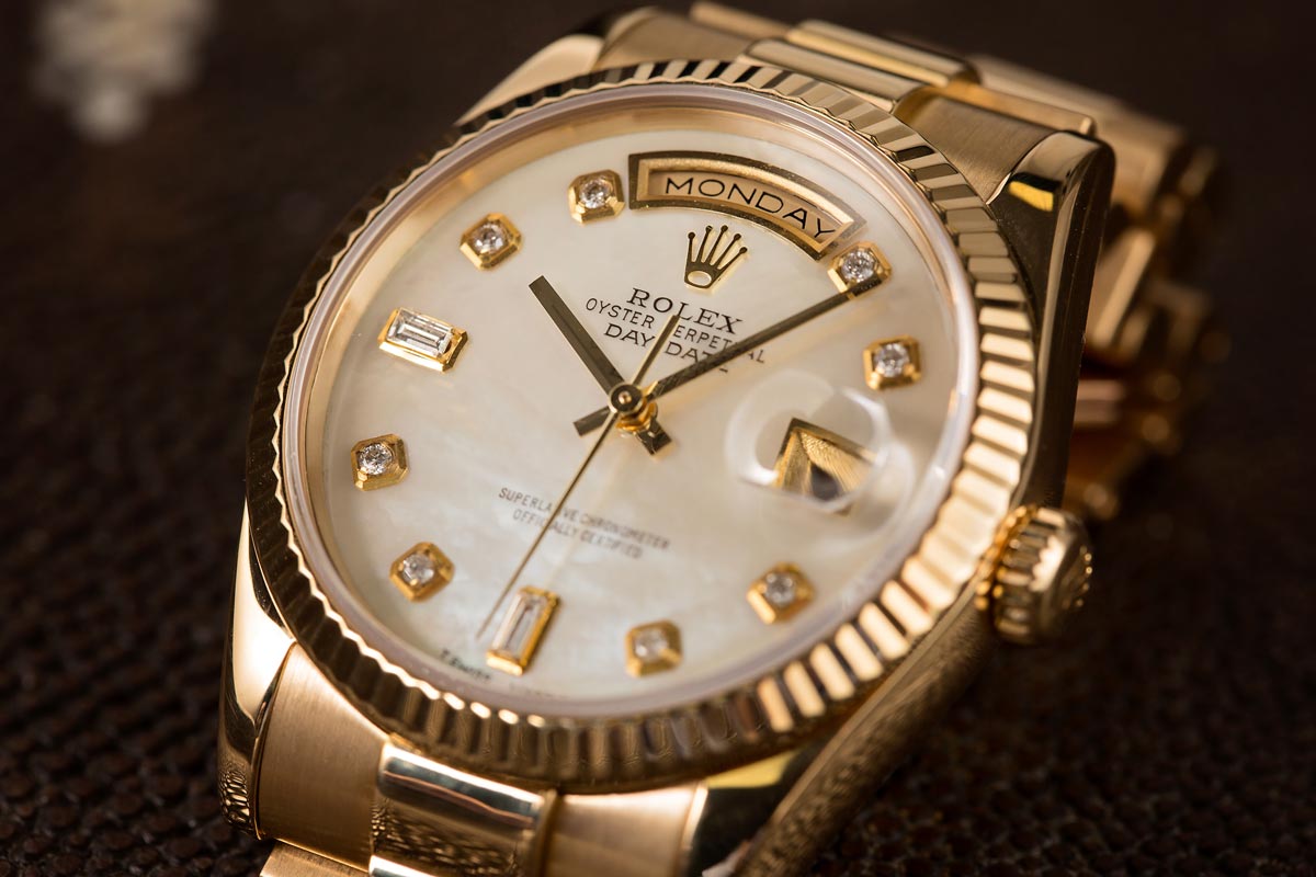 Rolex Day-Date in yellow gold with mother-of-pearl dial and diamond hour markers.