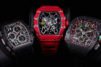 Three Richard Mille skeleton watches in black, red, and forged carbon cases displayed together in a luxury showcase.