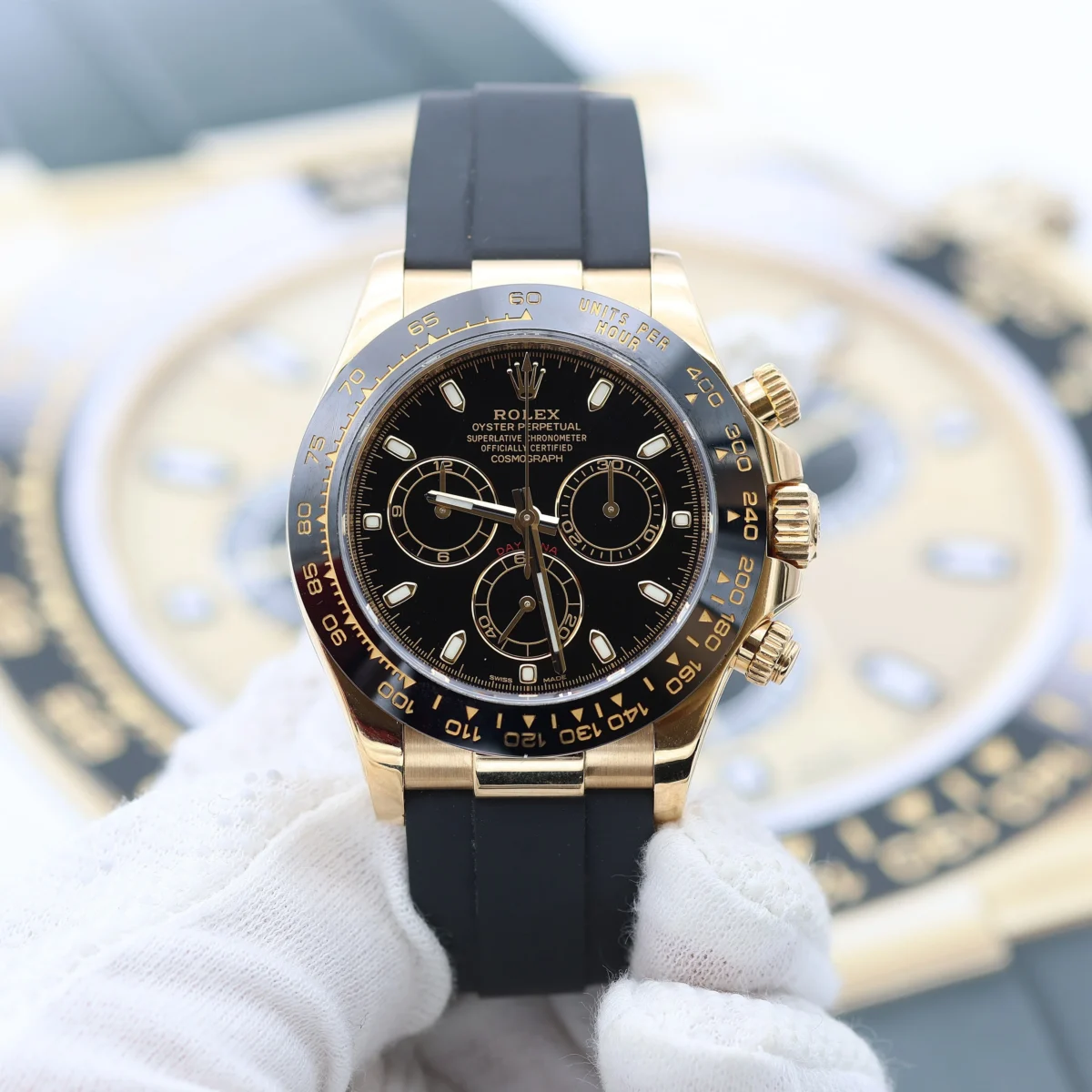 Rolex Daytona yellow gold chronograph with black dial and rubber strap luxury watch close-up
